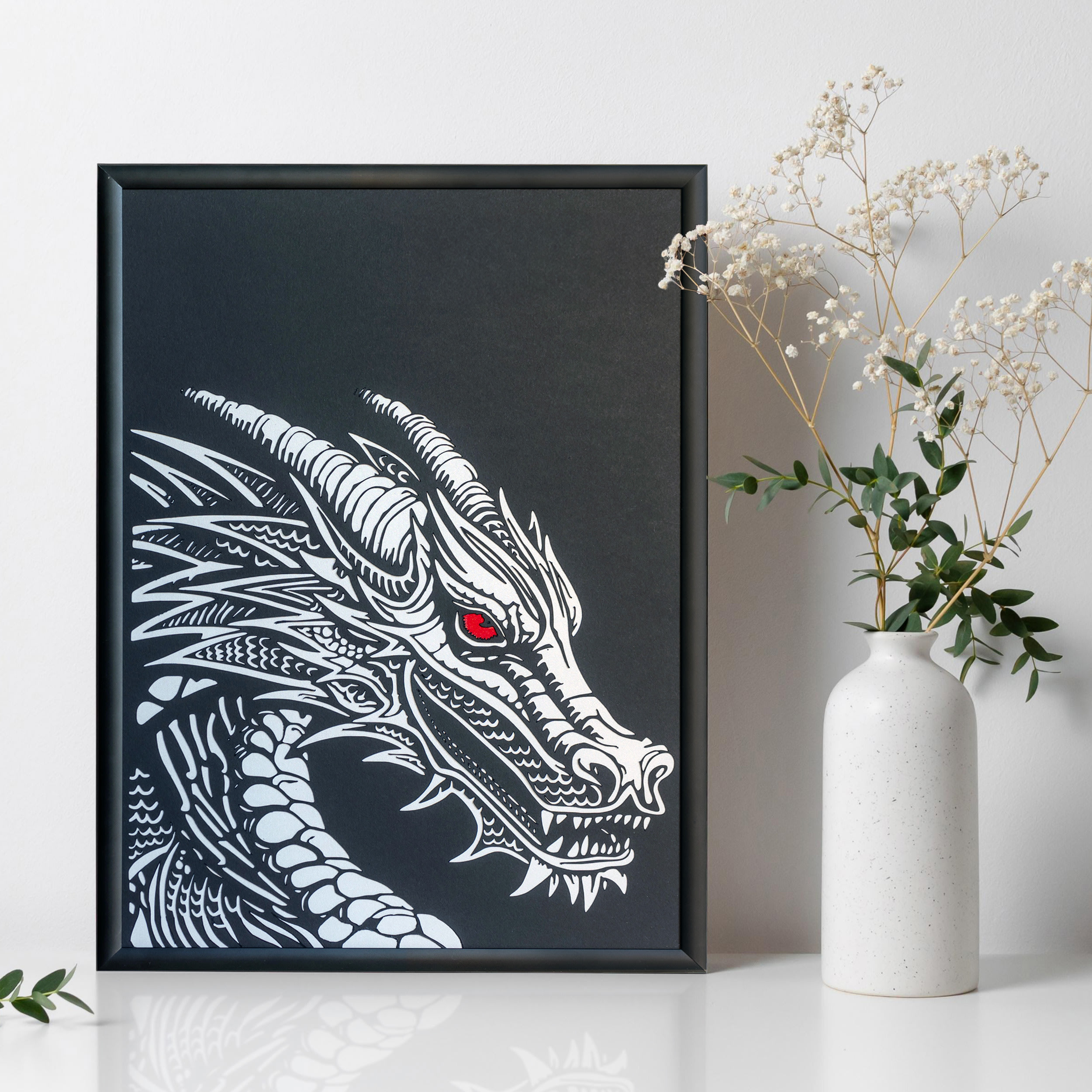 Dragon Papercut — bold single-layer paper cut showing a dragon with detailed wings, scales, and fierce pose, ready for framing