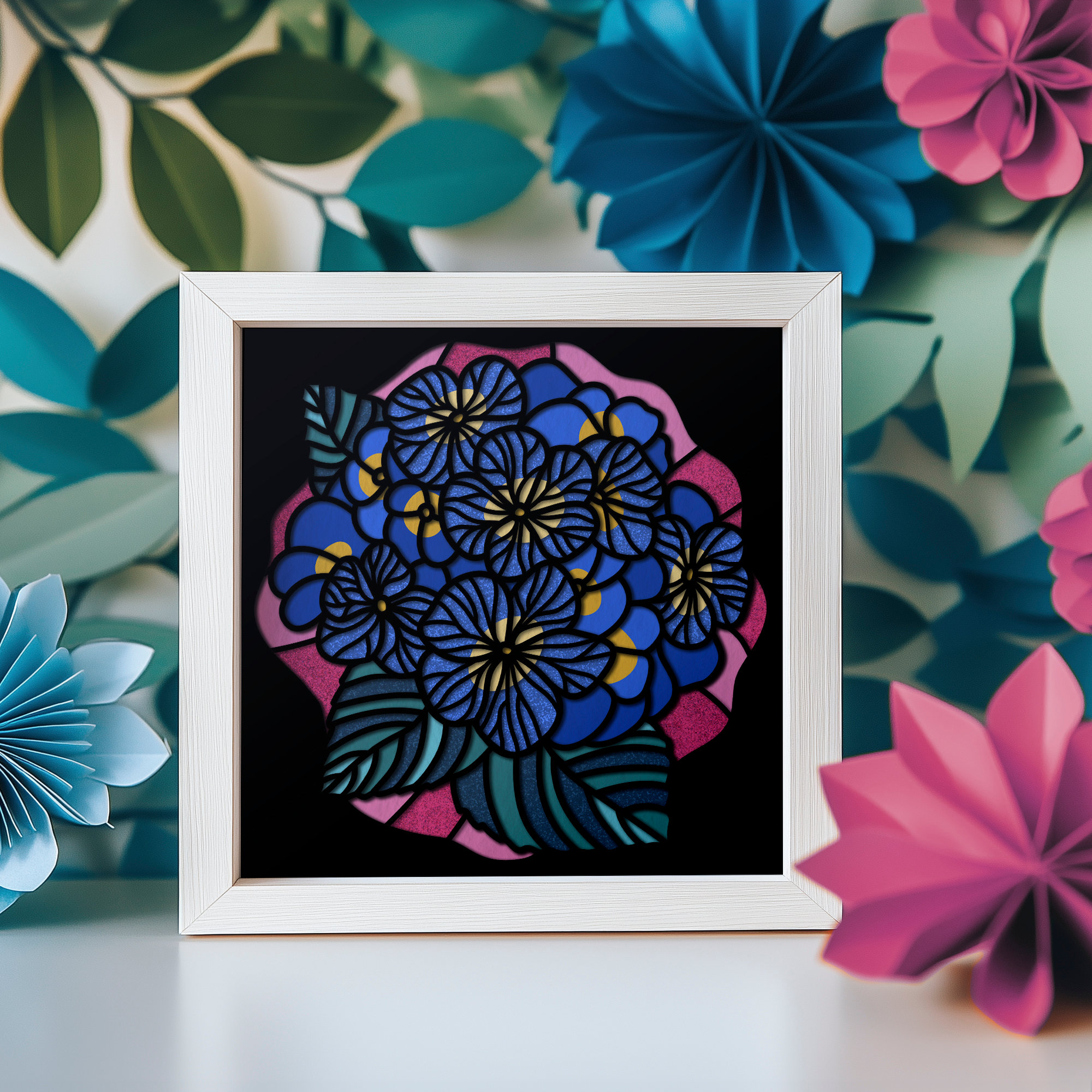 Colorful paper mosaic pieces arranged in shadow box